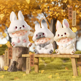 White bunny, grey bunny, and yellow bunny Yumo figures arranged outdoors in autumn scene.
