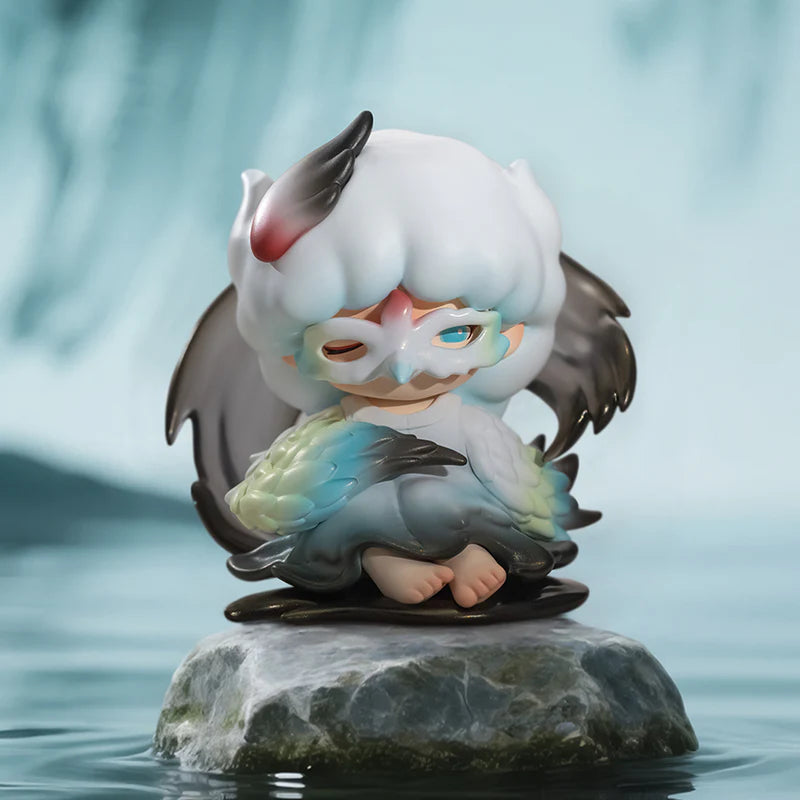 YUMO figure with mask and wings sitting on a rock in blue mystical environment