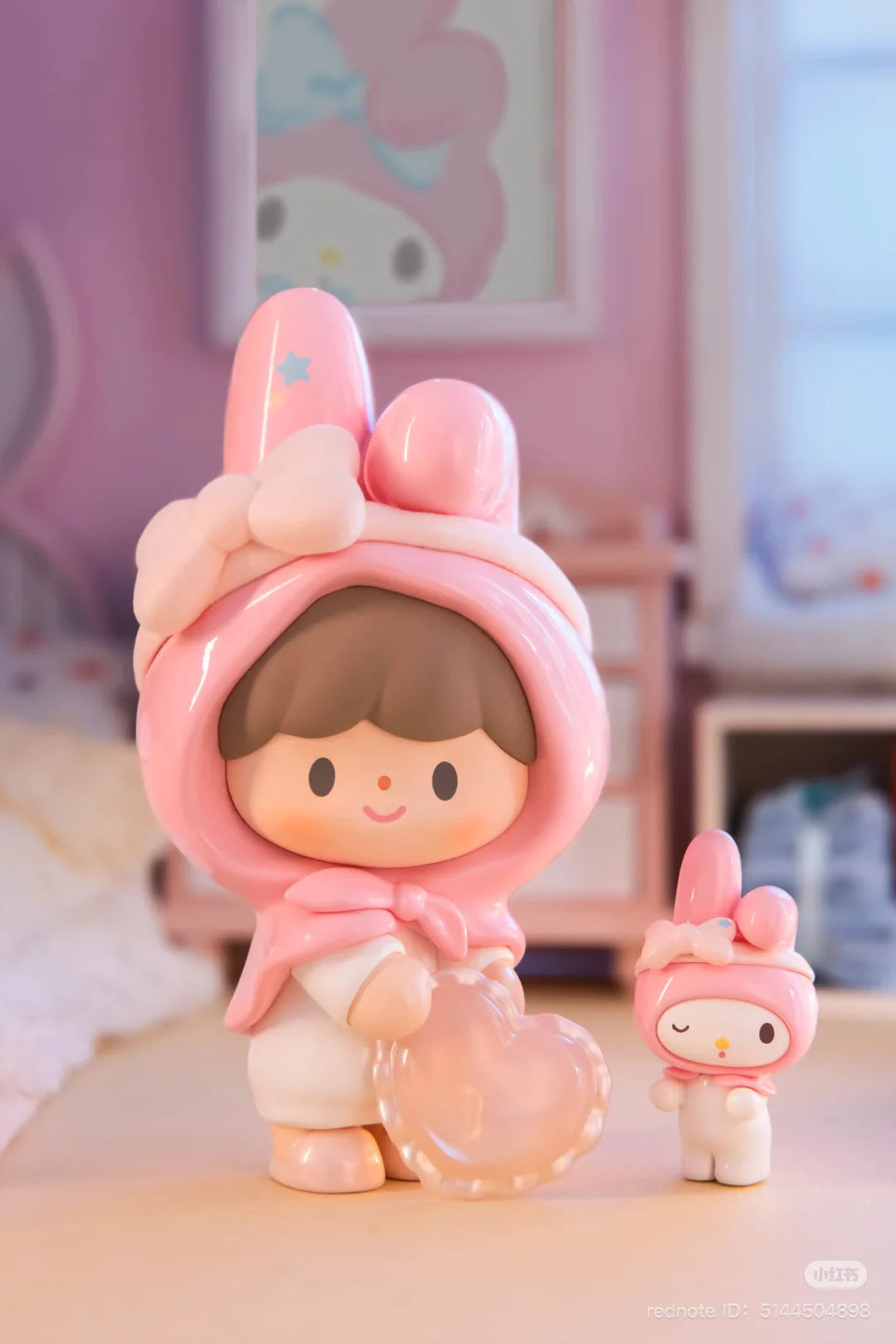 My Melody-themed zZoton figure holding a translucent heart beside a miniature companion