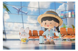 Let's Go zZoton figure holding a boarding pass and suitcase at an airport terminal with bunny companion